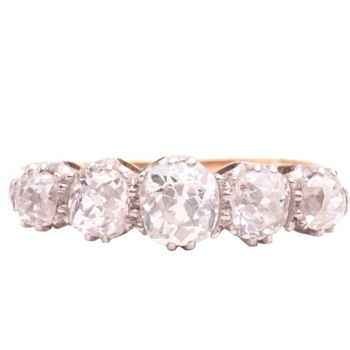 17 - A diamond five stone ring, set with a graduated row of cushion shape old cut diamonds with a total e... 