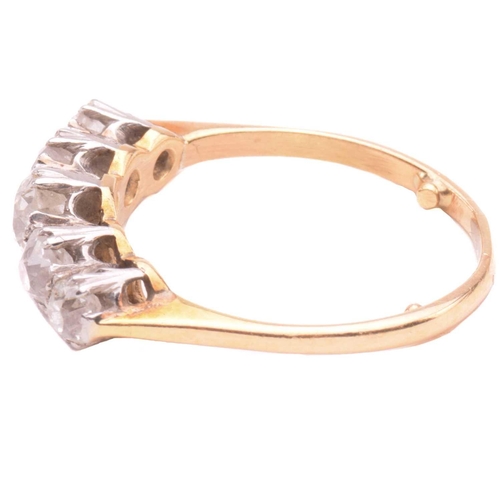 17 - A diamond five stone ring, set with a graduated row of cushion shape old cut diamonds with a total e... 