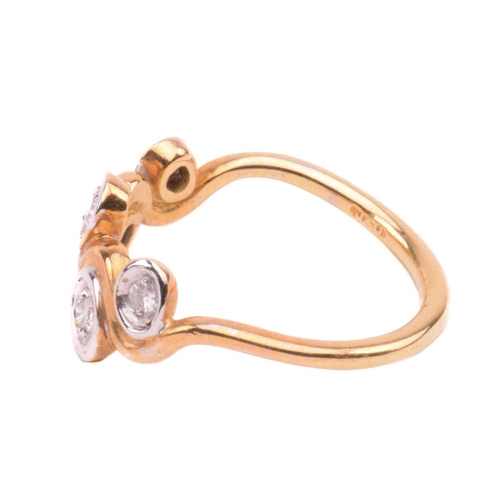 170 - A five stone diamond ring; the graduated round brilliant cut diamond in recessed bi-coloured 18 cara... 