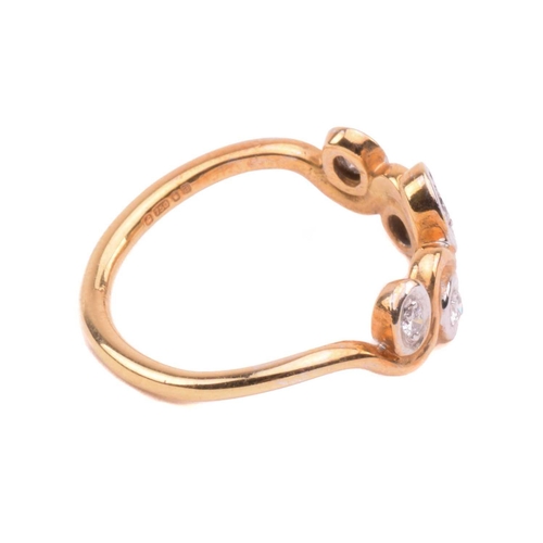 170 - A five stone diamond ring; the graduated round brilliant cut diamond in recessed bi-coloured 18 cara... 