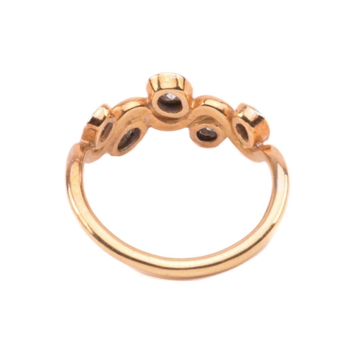 170 - A five stone diamond ring; the graduated round brilliant cut diamond in recessed bi-coloured 18 cara... 
