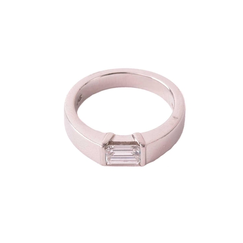 175 - A solitaire diamond ring, set with an emerald cut diamond with an estimated weight of 0.50ct, betwee... 