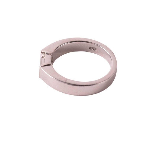 175 - A solitaire diamond ring, set with an emerald cut diamond with an estimated weight of 0.50ct, betwee... 