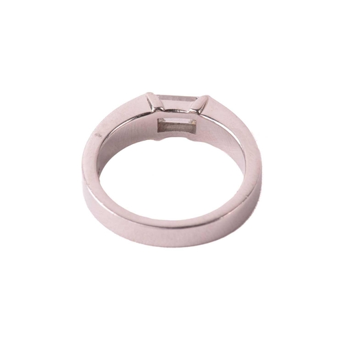 175 - A solitaire diamond ring, set with an emerald cut diamond with an estimated weight of 0.50ct, betwee... 