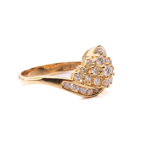 176 - A diamond crossover cluster ring, set with a central cluster of round brilliant cut diamonds between... 