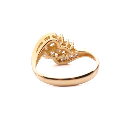 176 - A diamond crossover cluster ring, set with a central cluster of round brilliant cut diamonds between... 