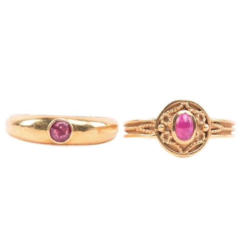 180 - A ruby ring, set with an oval cabochon ruby to the centre, with filigree decoration surround and fur... 
