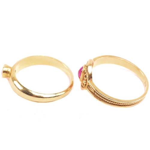 180 - A ruby ring, set with an oval cabochon ruby to the centre, with filigree decoration surround and fur... 