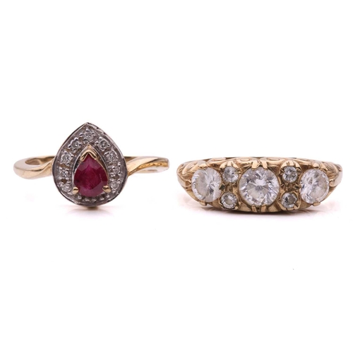 19 - Two gem-set dress rings; the ruby and diamond cluster ring, set with a pear shape ruby surrounded by... 