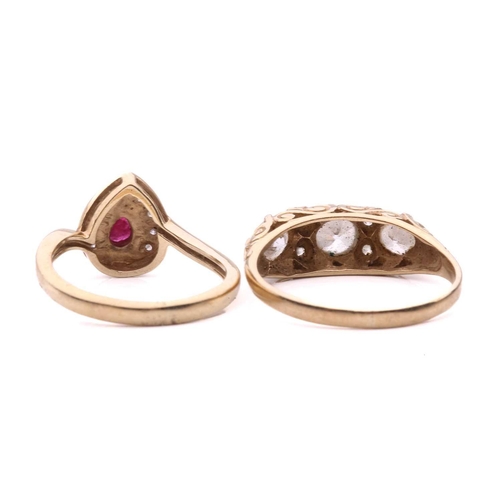 19 - Two gem-set dress rings; the ruby and diamond cluster ring, set with a pear shape ruby surrounded by... 