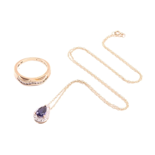 20 - An iolite and diamond drop shape pendant, the central pear shape iolite measuring 7.8mm x 5.6mm, wit... 