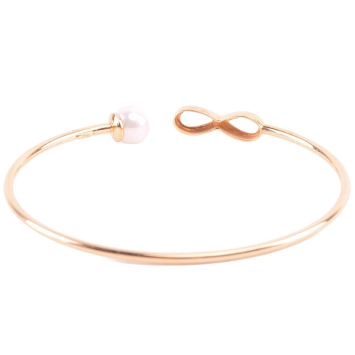 22 - A cultured pearl and CZ ring and other items with imitation pearls; the ring centred with a 7.2 mm r... 