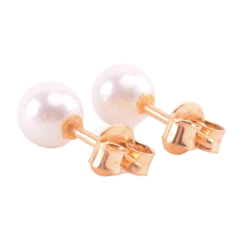 22 - A cultured pearl and CZ ring and other items with imitation pearls; the ring centred with a 7.2 mm r... 