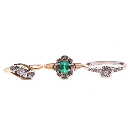 23 - A diamond three stone cross over ring, with a total estimated diamond weight of 0.12ct, the shank st... 
