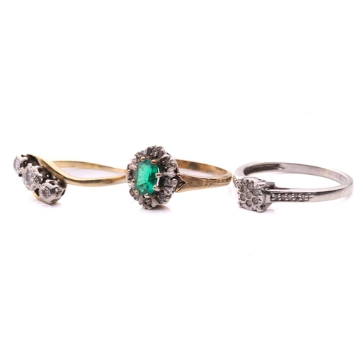 23 - A diamond three stone cross over ring, with a total estimated diamond weight of 0.12ct, the shank st... 