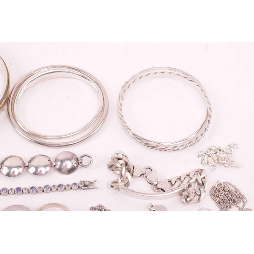 242 - A collection of jewellery in white metal, including ingot, cross, St Christopher, quartz pendants, e... 
