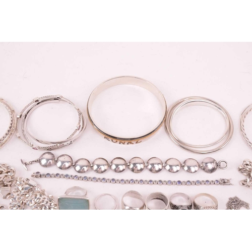 242 - A collection of jewellery in white metal, including ingot, cross, St Christopher, quartz pendants, e... 