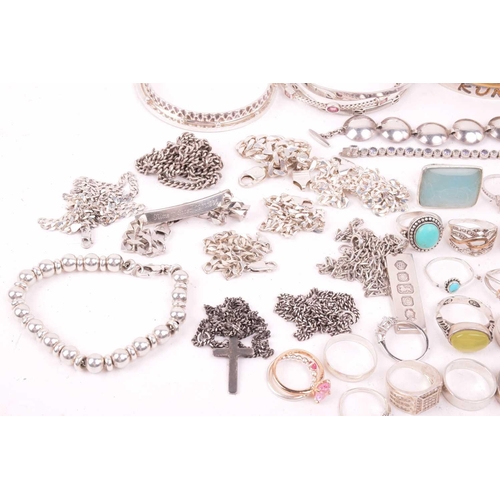 242 - A collection of jewellery in white metal, including ingot, cross, St Christopher, quartz pendants, e... 