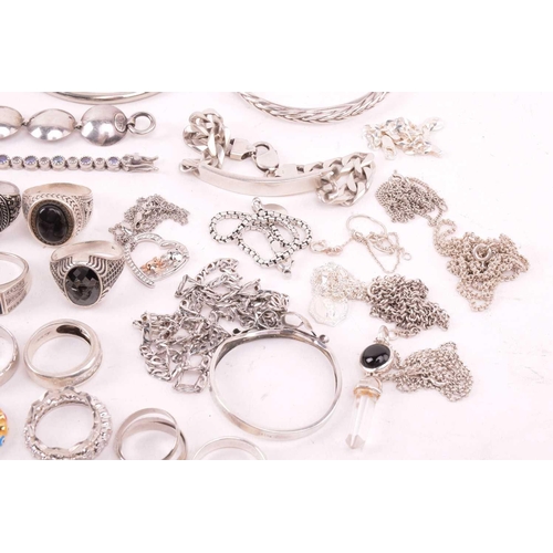 242 - A collection of jewellery in white metal, including ingot, cross, St Christopher, quartz pendants, e... 