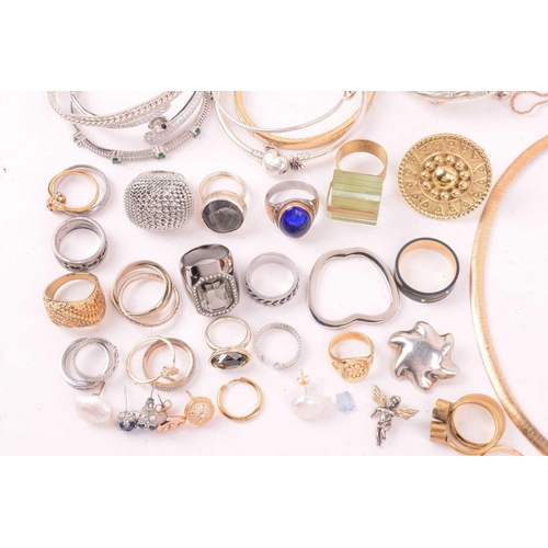 247 - A large collection of jewellery in base metal, including pendants, earrings and rings, and further b... 