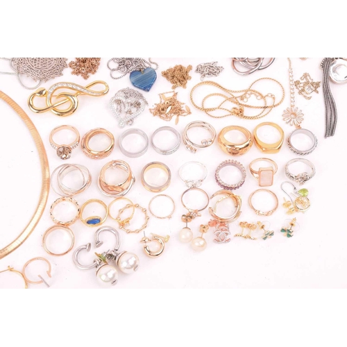 247 - A large collection of jewellery in base metal, including pendants, earrings and rings, and further b... 