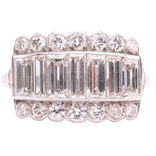 249 - A diamond ring, set with a central row of baguette cut diamonds between rows of round brilliant cut ... 