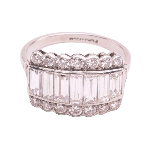 249 - A diamond ring, set with a central row of baguette cut diamonds between rows of round brilliant cut ... 