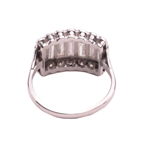 249 - A diamond ring, set with a central row of baguette cut diamonds between rows of round brilliant cut ... 