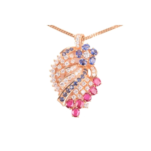 25 - A diamond, ruby and sapphire spray pendant on chain; the stylised spray comprising a six stone sapph... 
