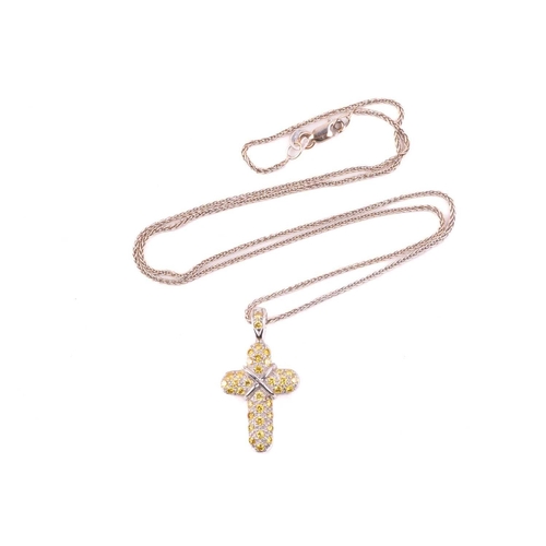 252 - A yellow diamond cross pendant, set with round brilliant cut yellow diamonds with a total diamond we... 