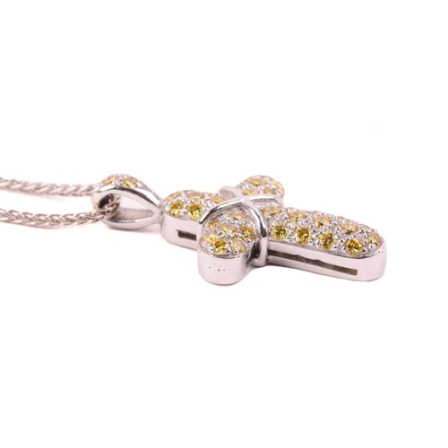 252 - A yellow diamond cross pendant, set with round brilliant cut yellow diamonds with a total diamond we... 