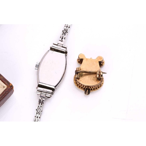 253 - A platinum and diamond cocktail watch, the tonneau-shaped case set with mixed old cut diamonds, mech... 