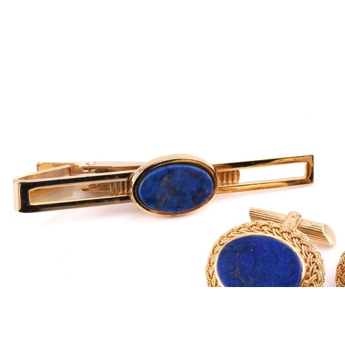 255 - A pair of lapis lazuli cufflinks with filigree surround, marked 'Italy 18k', a lapis lazuli signet r... 