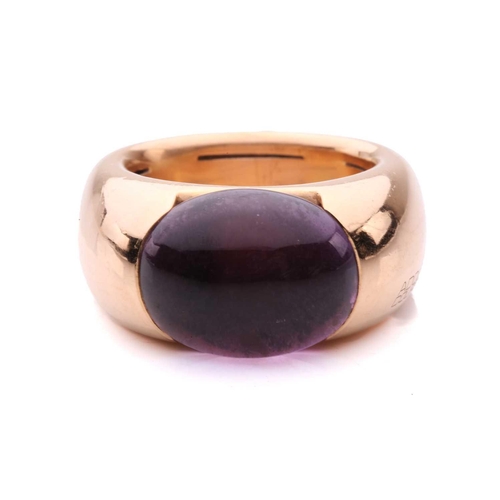258 - An amethyst cocktail ring by Adolfo Courrier, centred with an oval amethyst cabochon in a closed-bac... 