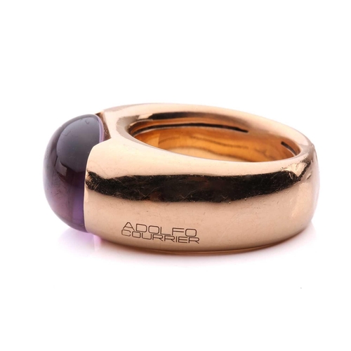 258 - An amethyst cocktail ring by Adolfo Courrier, centred with an oval amethyst cabochon in a closed-bac... 
