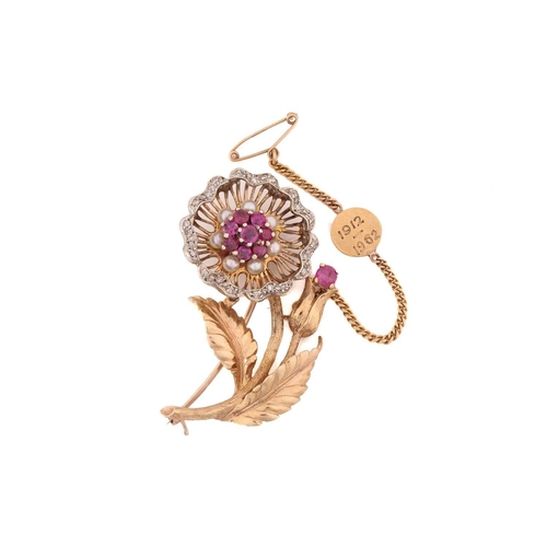 259 - A gem-set flower spray brooch in 18ct gold, the wirework flowerhead edged with diamond accents, cent... 