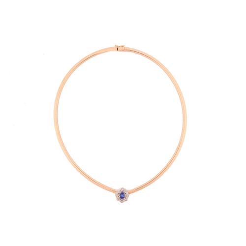 26 - A tanzanite and diamond cluster necklace, centred with an oval-cut tanzanite of 7.1 x 5.1 mm, within... 