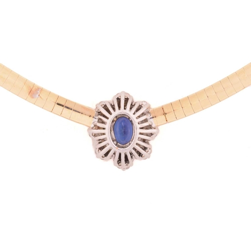 26 - A tanzanite and diamond cluster necklace, centred with an oval-cut tanzanite of 7.1 x 5.1 mm, within... 