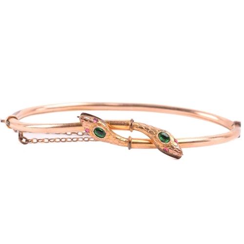262 - A Victorian snake bangle set with paste, with an inner diameter of 6.4cm, a bangle with engraved des... 