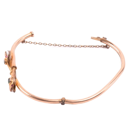 262 - A Victorian snake bangle set with paste, with an inner diameter of 6.4cm, a bangle with engraved des... 