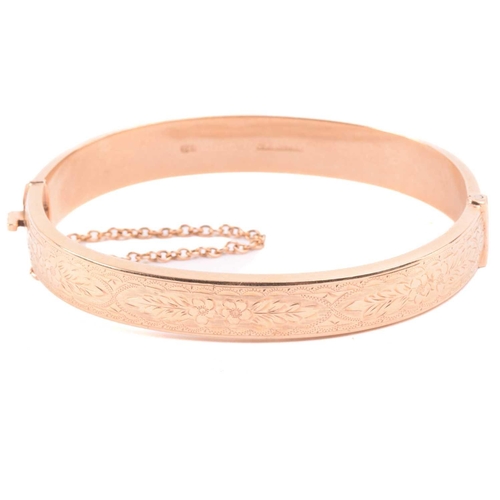 262 - A Victorian snake bangle set with paste, with an inner diameter of 6.4cm, a bangle with engraved des... 