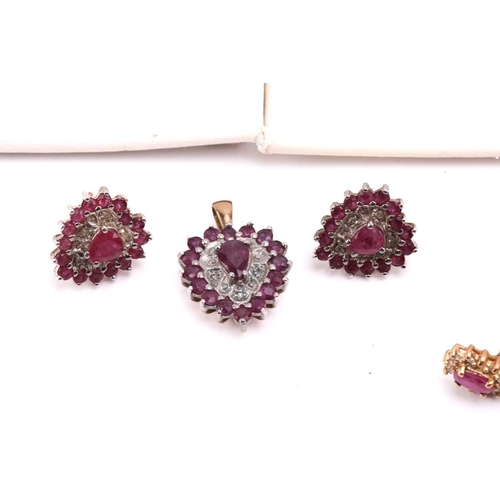 264 - Twelve pairs of earrings and a ruby set pendant. The first pair of stud earrings comprise a heart sh... 