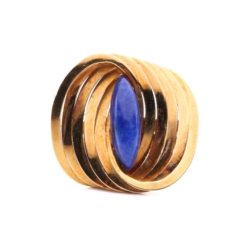 267 - A Modernist lapis lazuli cocktail ring in 18ct gold, composed of interlocking polished oval rings, c... 