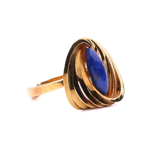267 - A Modernist lapis lazuli cocktail ring in 18ct gold, composed of interlocking polished oval rings, c... 
