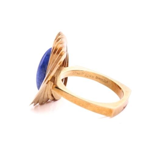 267 - A Modernist lapis lazuli cocktail ring in 18ct gold, composed of interlocking polished oval rings, c... 