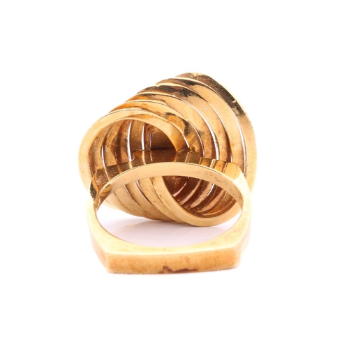 267 - A Modernist lapis lazuli cocktail ring in 18ct gold, composed of interlocking polished oval rings, c... 