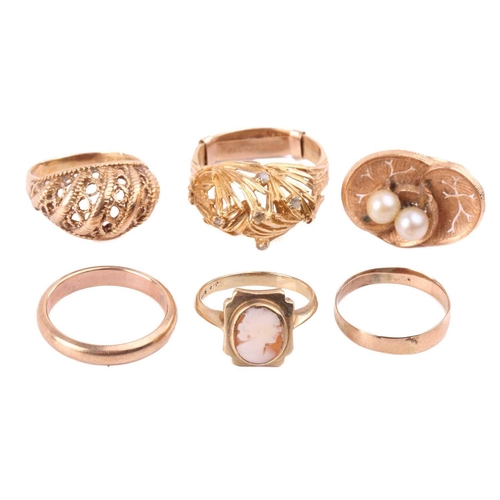 272 - A group of six dress rings; including a bombé ring of foliate design, with a later added shank, head... 