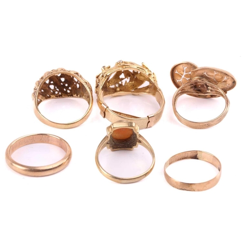 272 - A group of six dress rings; including a bombé ring of foliate design, with a later added shank, head... 