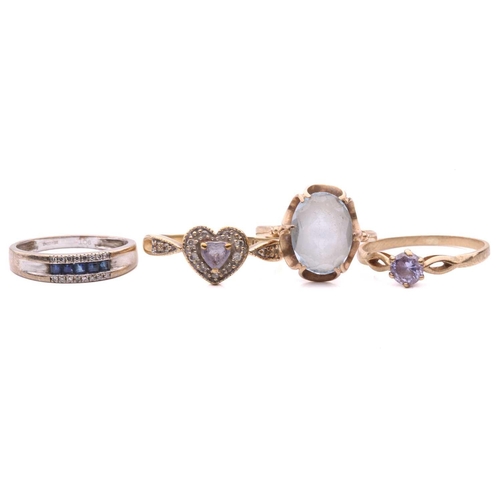 276 - A sapphire and diamond ring, set with a row of square step cut sapphires between rows of single cut ... 
