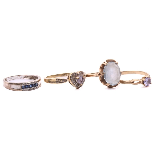 276 - A sapphire and diamond ring, set with a row of square step cut sapphires between rows of single cut ... 